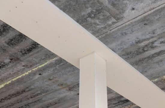 Ondersteunende kolom en betonnen plafond in een constructie, relevant voor brandveiligheidsoplossingen van Grazy Brandwering.